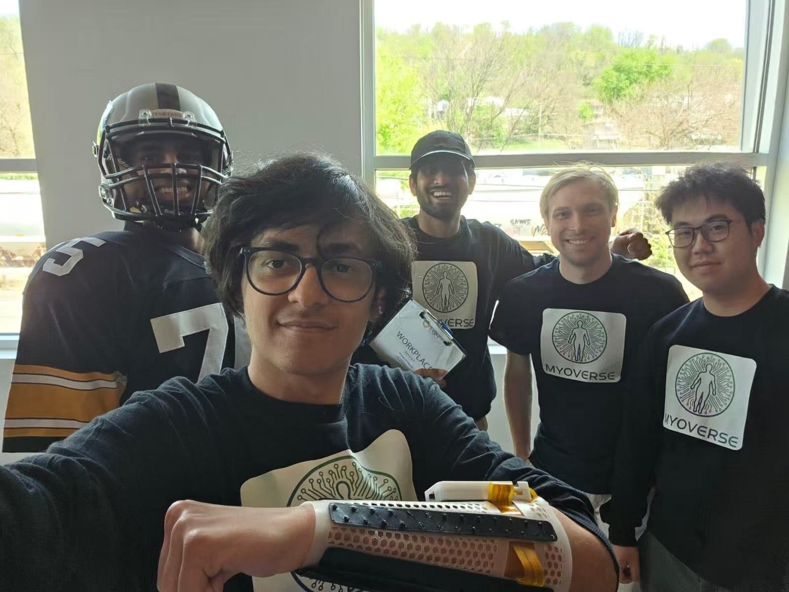 MyoVerse team demonstrating a wearable EMG sleeve prototype